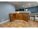 Basement bar with wood cabinets, granite countertop, and wine rack at 327 Johnson Dairy Rd, Mooresville, NC 28115
