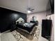 Main bedroom with a king-size bed, dark accent wall, and ceiling fan at 327 Johnson Dairy Rd, Mooresville, NC 28115