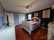 Bedroom with hardwood floors, white bed frame, and navy blue walls at 327 Johnson Dairy Rd, Mooresville, NC 28115
