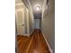 Hardwood floor hallway with gray walls and neutral decor at 327 Johnson Dairy Rd, Mooresville, NC 28115