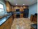 Kitchen with wood cabinets, granite countertops, and stainless steel appliances at 327 Johnson Dairy Rd, Mooresville, NC 28115