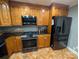 Kitchen boasts wood cabinets, granite counters, and stainless steel appliances at 327 Johnson Dairy Rd, Mooresville, NC 28115