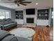 Living room features hardwood floors, fireplace and built-in shelving at 327 Johnson Dairy Rd, Mooresville, NC 28115