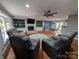 Open-concept living room with built-in shelving, a fireplace, hardwood floors, and modern ceiling fan at 327 Johnson Dairy Rd, Mooresville, NC 28115