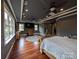 Large main bedroom with hardwood floors, multiple windows, and a ceiling fan at 327 Johnson Dairy Rd, Mooresville, NC 28115
