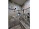 Spacious walk-in shower with tiled walls and built-in shelving at 327 Johnson Dairy Rd, Mooresville, NC 28115