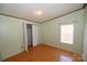 Simple bedroom with light green walls and laminate floors at 3463 Rock Creek Dr, Newton, NC 28658
