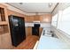 View of kitchen with black appliances and light wood cabinets at 3463 Rock Creek Dr, Newton, NC 28658