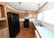 Kitchen with wood cabinets and black appliances at 3463 Rock Creek Dr, Newton, NC 28658