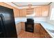 Close-up of kitchen with black appliances and light wood cabinets at 3463 Rock Creek Dr, Newton, NC 28658