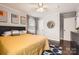 Spacious bedroom with a mustard yellow comforter and dark wood floors at 3512 Carlyle Dr, Charlotte, NC 28208