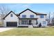 Stunning two-story modern farmhouse exterior with a black trim and a front porch at 3621 Carmel Forest Dr, Charlotte, NC 28226