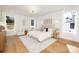 A spacious and bright main bedroom featuring hardwood floors, neutral paint, and modern fixtures at 3621 Carmel Forest Dr, Charlotte, NC 28226