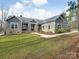 Gray siding, stone accents, and a welcoming porch characterize this charming house at 4071 Wycoff Rd, Sharon, SC 29742