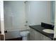 Clean bathroom with bathtub, toilet, and modern vanity at 411 E Gary St, Candor, NC 27229
