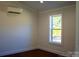 Bedroom with a window and dark stained wood floors at 411 E Gary St, Candor, NC 27229
