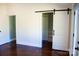 Spacious bedroom with a large closet and dark stained floors at 411 E Gary St, Candor, NC 27229