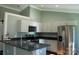 Modern kitchen with stainless steel appliances and dark countertops at 411 E Gary St, Candor, NC 27229