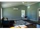 Spacious living room with vaulted ceiling, stained concrete floor, and comfy seating at 411 E Gary St, Candor, NC 27229