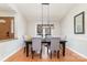 Dining area with a dark wood table, gray chairs, and a chandelier at 4426 Appaloosa Ln, Charlotte, NC 28215