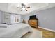 Bedroom with hardwood floors, ceiling fan, and large windows at 5669 Berry Ridge Dr, Harrisburg, NC 28075