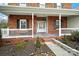 Inviting front porch with white railings and brick columns at 5669 Berry Ridge Dr, Harrisburg, NC 28075