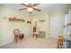 Well-lit bedroom with a chair, shelving, and access to a bathroom at 6330 Rhodins Ln, Fort Mill, SC 29707