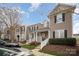 Townhome community with multiple tan colored houses and parking at 6330 Rhodins Ln, Fort Mill, SC 29707