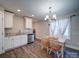 Kitchen dining area with chandelier and farmhouse table at 64 Willow St, Badin, NC 28009