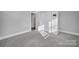 Bright bedroom with grey carpeting and double door closet at 709 Grass Dr, Charlotte, NC 28216