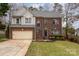 Attractive brick home featuring a manicured lawn, well-maintained landscaping, and a two-car garage at 100 Melrose Ct, Fort Mill, SC 29715