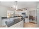 Well-lit kitchen featuring white cabinets, granite countertops, and a tiled backsplash at 100 Melrose Ct, Fort Mill, SC 29715