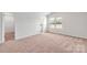 Spacious bedroom with carpet flooring and a large window at 103 Adams Tree Way, Troutman, NC 28166