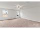 Spacious bedroom with neutral carpeting and two large windows at 103 Adams Tree Way, Troutman, NC 28166