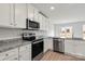 Kitchen with white cabinets, granite countertops, and stainless steel appliances at 103 Adams Tree Way, Troutman, NC 28166