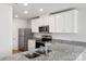 Modern kitchen with stainless steel appliances and granite countertops at 103 Adams Tree Way, Troutman, NC 28166