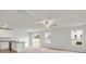 Bright living room with a sliding glass door, neutral carpeting, and ceiling fan at 103 Adams Tree Way, Troutman, NC 28166