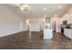 Open concept living area with hardwood floors and kitchen at 111 Adams Tree Way, Troutman, NC 28166