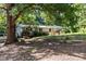 Side view of a single story home with a large tree and swing set at 12180 Coyle Rd # A, Stanfield, NC 28163