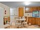 A small kitchen with wood cabinets and a round table with chairs at 12180 Coyle Rd # A, Stanfield, NC 28163