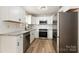 Modern kitchen featuring white cabinets, granite countertops, and stainless steel appliances at 123 Hemlock Dr, Salisbury, NC 28147