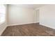 Simple room with wood-look floors, neutral walls, and a doorway at 162 Wembury Ln, Troutman, NC 28166