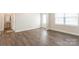 Empty room with wood-look floors, white walls, and a half bathroom at 162 Wembury Ln, Troutman, NC 28166