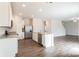Open concept kitchen with island, stainless steel appliances, and hardwood floors at 162 Wembury Ln, Troutman, NC 28166