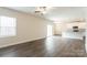 Open living room with kitchen views, wood-look floors, and a ceiling fan at 162 Wembury Ln, Troutman, NC 28166