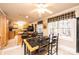 Kitchen dining area with tile table and chairs, and access to the kitchen at 165 Pine Valley Dr, Stanley, NC 28164