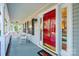 Front porch with rocking chairs and red front door at 165 Pine Valley Dr, Stanley, NC 28164