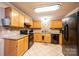 Kitchen boasts granite countertops, ample cabinetry, and black appliances at 165 Pine Valley Dr, Stanley, NC 28164
