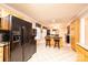 Kitchen with black appliances, tile floors, and island with seating at 165 Pine Valley Dr, Stanley, NC 28164