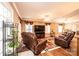 Relaxing living room with hardwood floors, leather furniture, and large TV at 165 Pine Valley Dr, Stanley, NC 28164